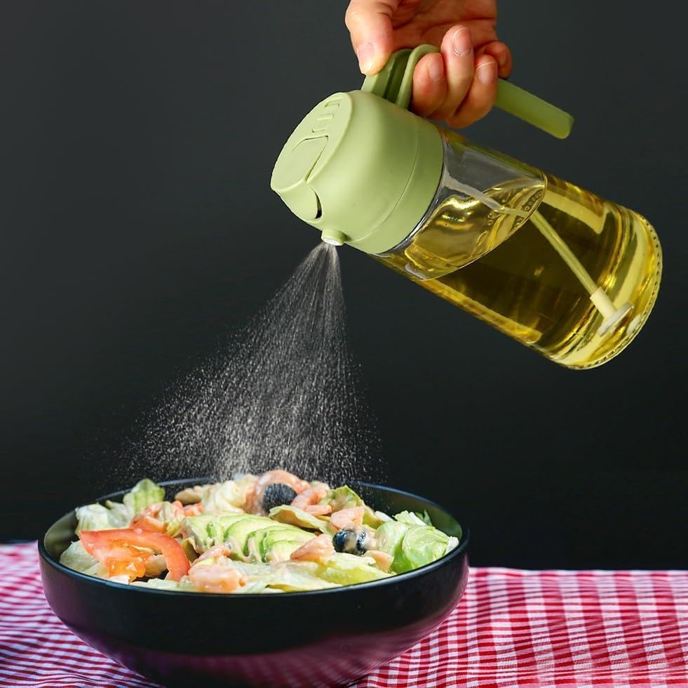 Person using a bottle to sprinkle dressing over a salad on a checkered tablecloth.