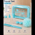 A turquoise and clear City of Blanco travel set with 8 pieces, including a toiletry bag, pump bottle, spray bottle, small containers, comb, and loofa, displayed on a light marble surface with a wooden background.