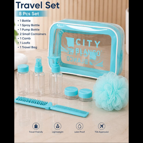 A turquoise and clear City of Blanco travel set with 8 pieces, including a toiletry bag, pump bottle, spray bottle, small containers, comb, and loofa, displayed on a light marble surface with a wooden background.