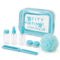 A toiletry kit set with a light blue and white zippered case, three clear bottles, two small jars, a blue-and-white comb, and a light blue loofah sponge on a white background. The case label shows the brand name 'CITY BLANCO'.
