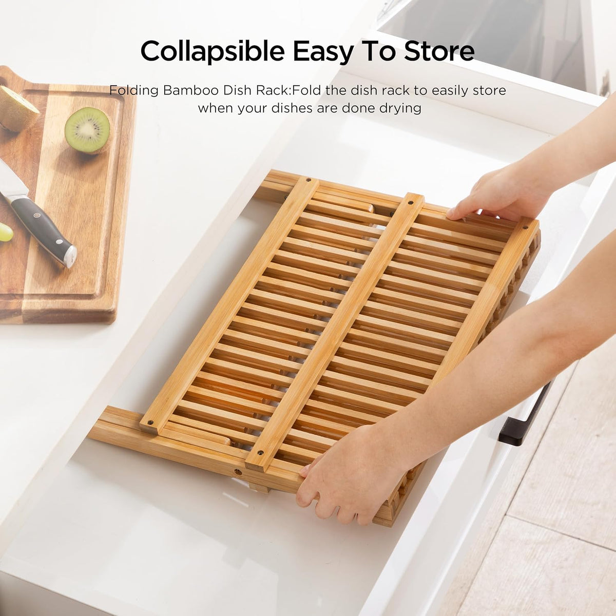 Collapsible bamboo dish rack on a kitchen counter with text indicating its collapsible design.