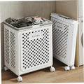 White laundry basket with 'DOUBA' branding on a wooden floor.