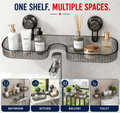A gray translucent plastic bathroom shelf mounted with two black suction cups above a sink faucet. The shelf holds several bathroom items, including bottles, a reed diffuser, and a round container.