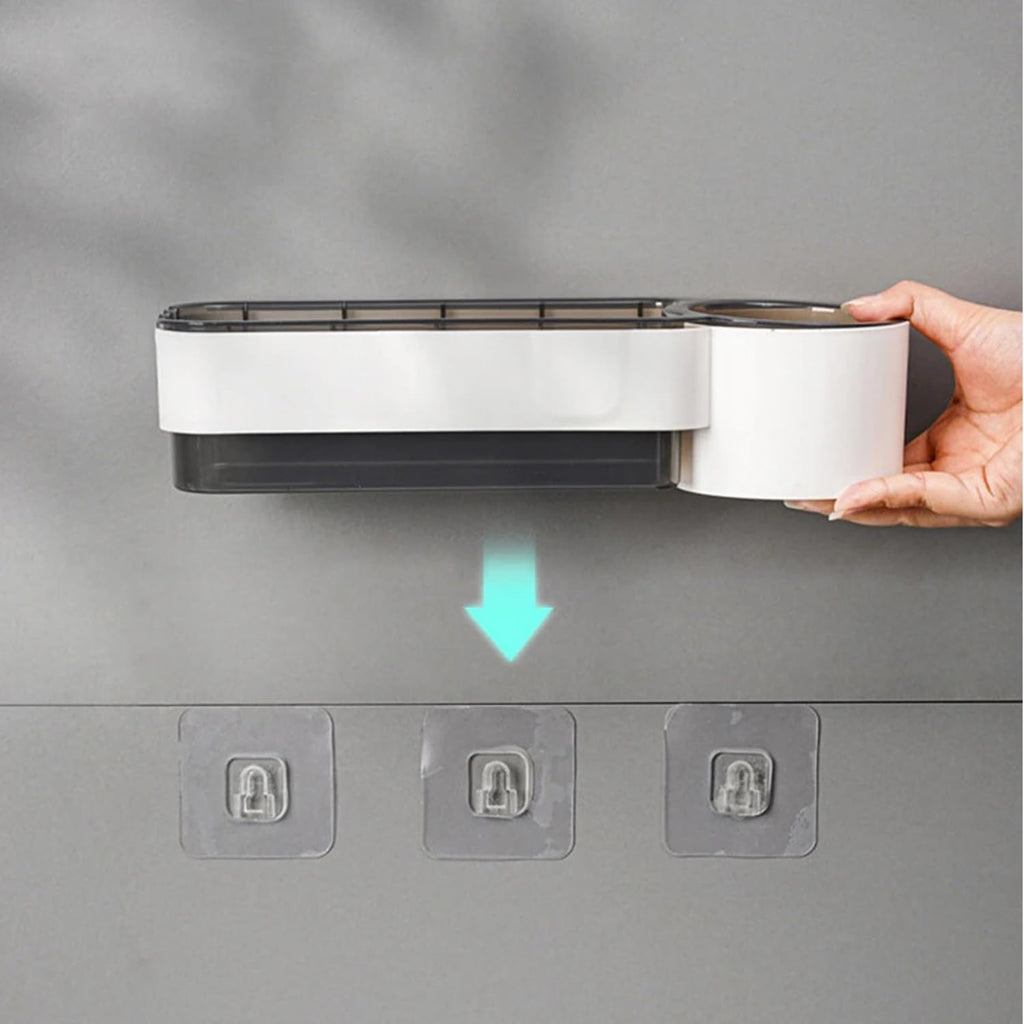 Hand holding a white and black device with a green arrow on a gray background