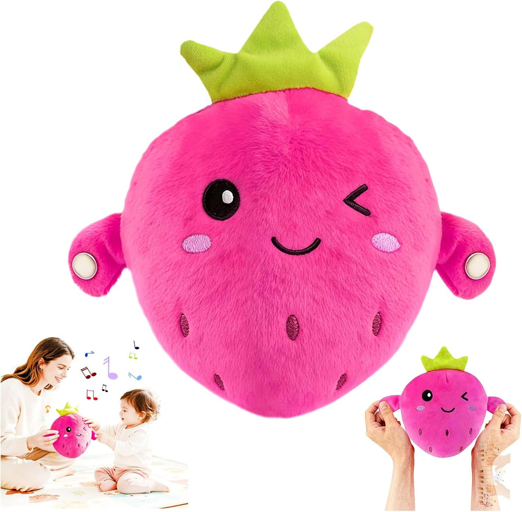 A large plush strawberry toy in bright pink with a green crown and embroidered face, shown on a white background. Two small inset photos at the bottom show a woman and child holding and playing with the toy, and another inset shows hands holding the toy.