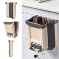 A beige and dark gray wall-mounted hanging trash can with a liner and pull-out lid, shown in multiple views including side, front, and top-down angles, plus one installed on a bathroom cabinet.