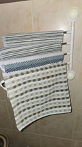Beiryta four-arm rotating no-drill towel rack installed on bathroom tiles with towels