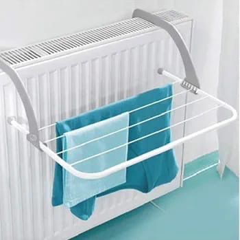 A white wall-mounted radiator clothesline with gray support brackets, shown holding blue towels in front of a white radiator.