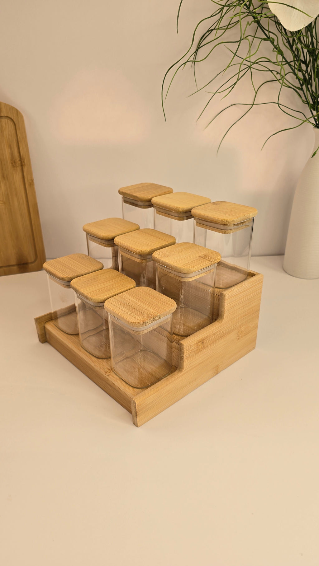 Side view of the three-tier bamboo spice rack with nine glass jars