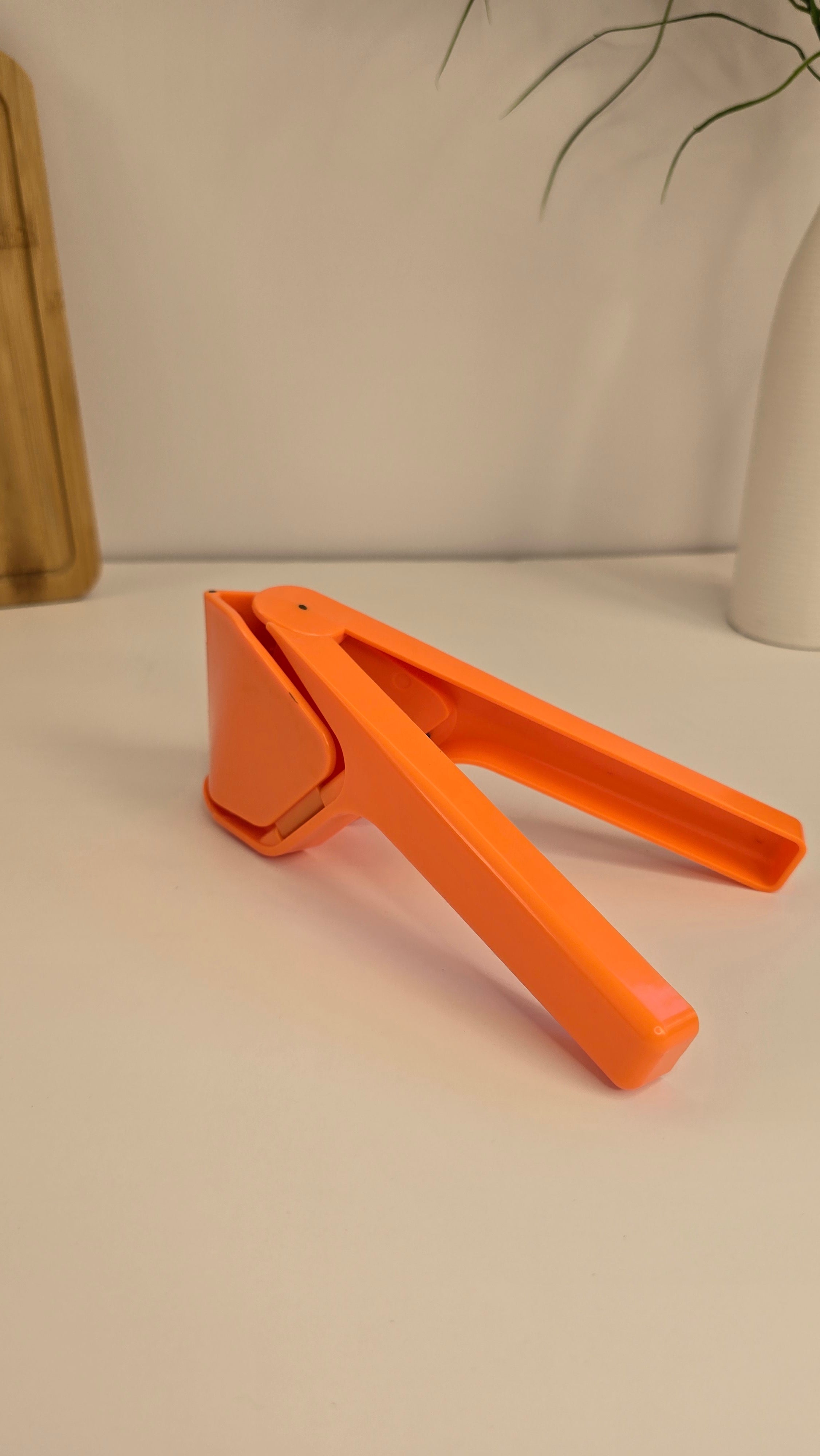 Orange Beiryta manual lemon juicer on a clean kitchen background