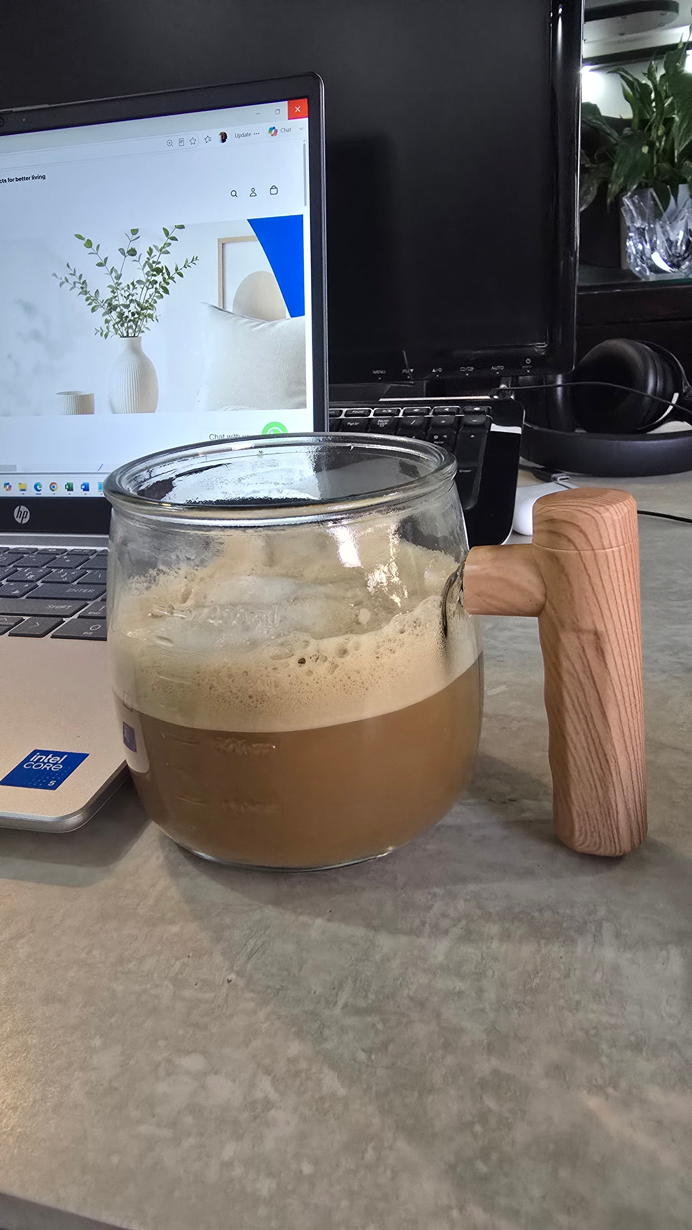 Beiryta handheld electric milk frother mixing coffee for a rich and creamy drink.