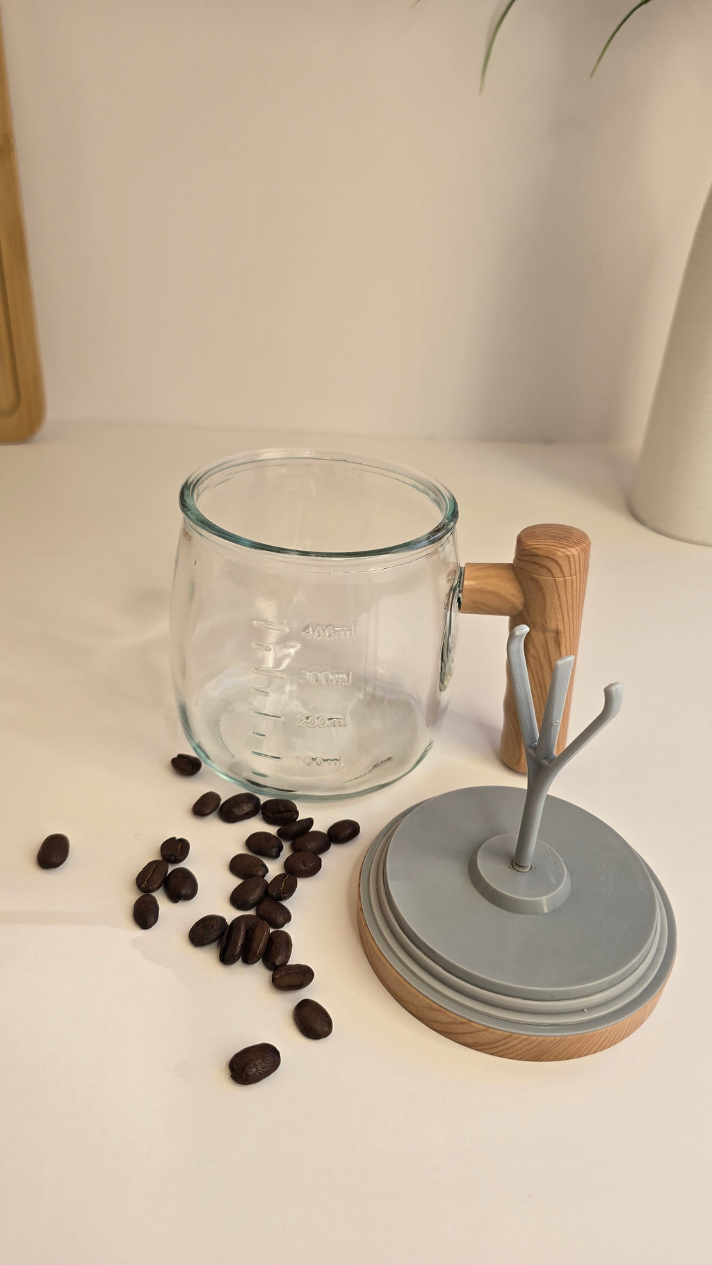 Beiryta handheld electric milk frother with stainless steel whisk and countertop stand.