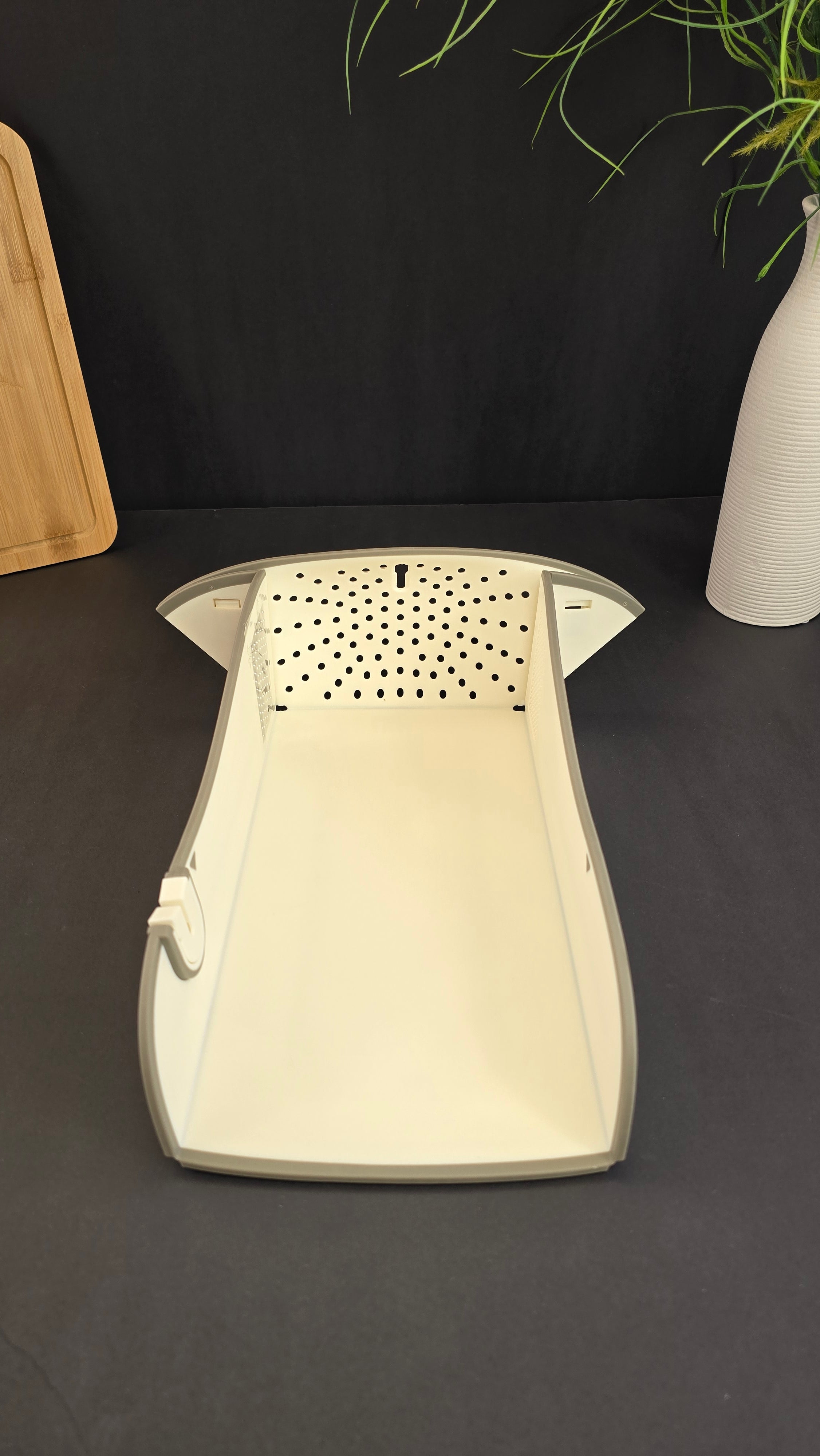 Open multifunctional cutting board with raised sides, drainage holes and built-in grater