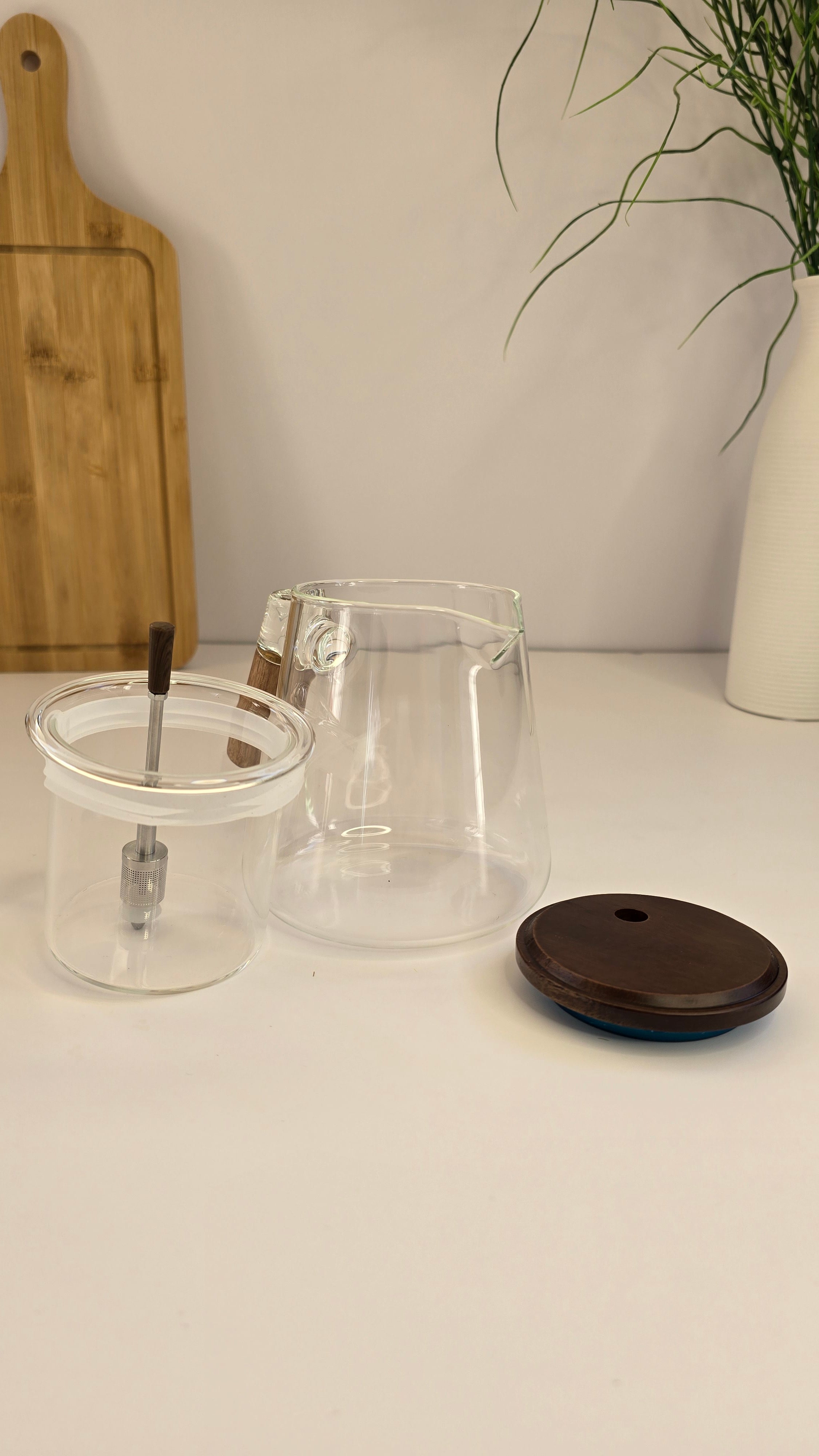 Glass teapot displayed with its lid and removable stainless-steel tea infuser