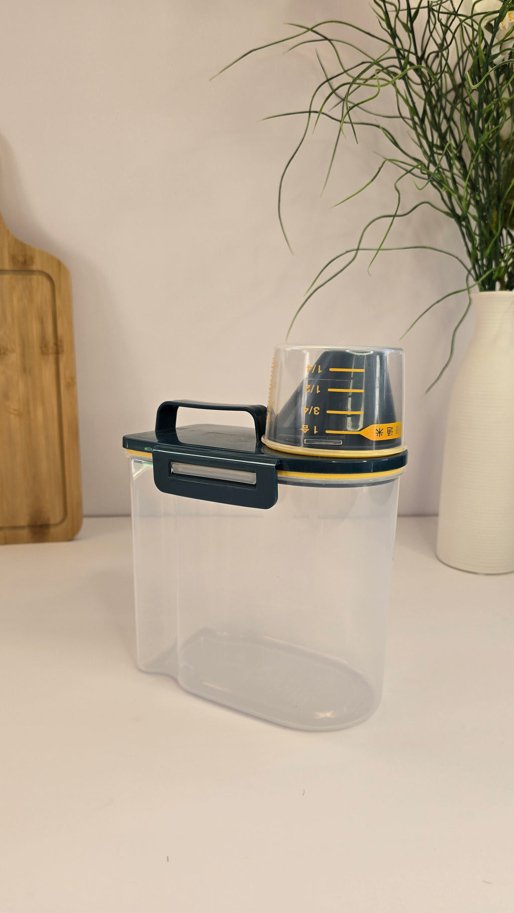 Side view of Beiryta grain dispenser with handle and removable measuring cup