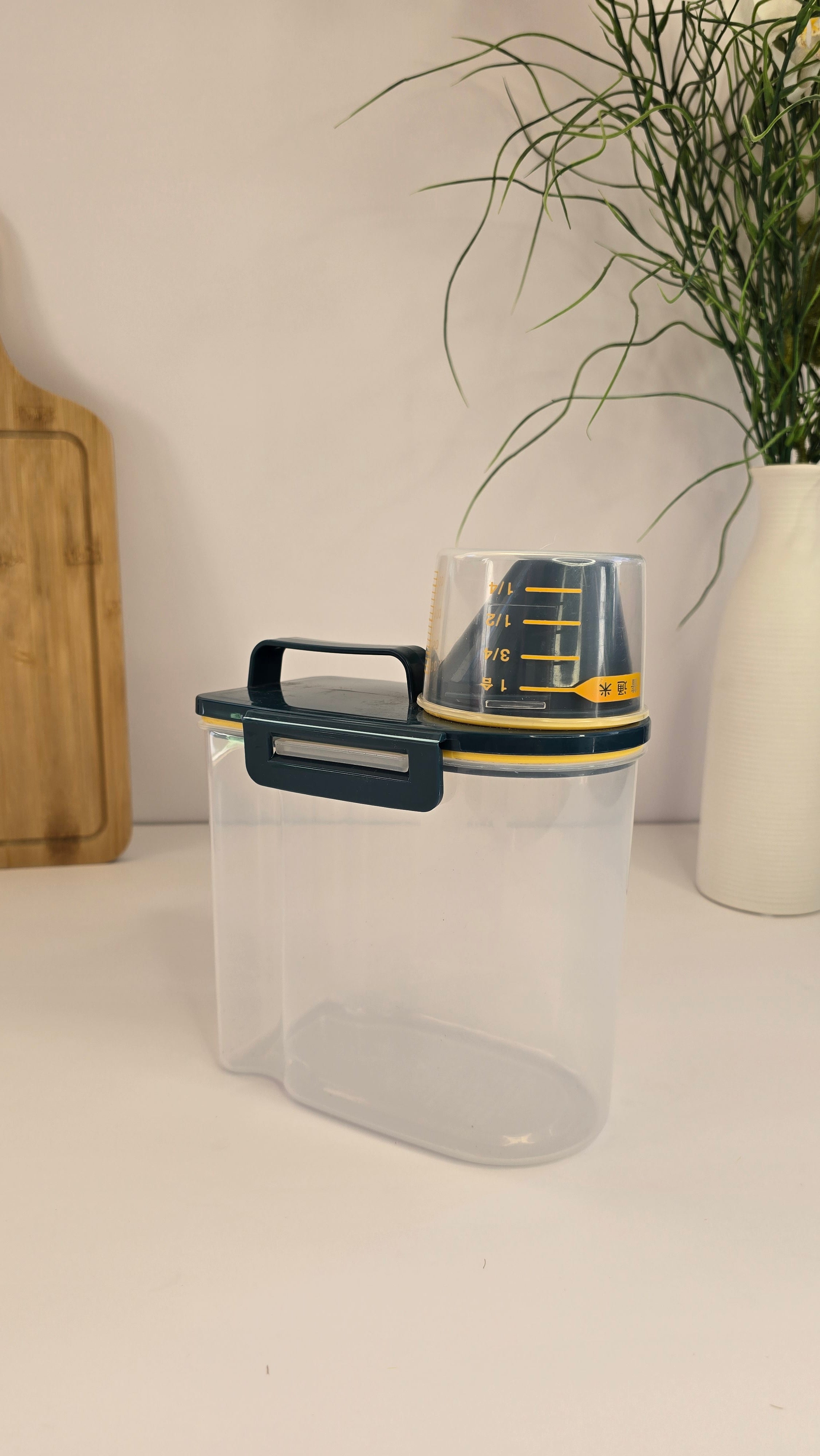 Side view of Beiryta grain dispenser with handle and removable measuring cup