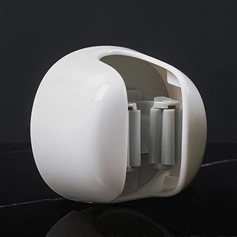 Two modern capsule-shaped electronic devices on a glossy black reflective surface against a dark background. The left device is matte white and open, showing gray internal components.