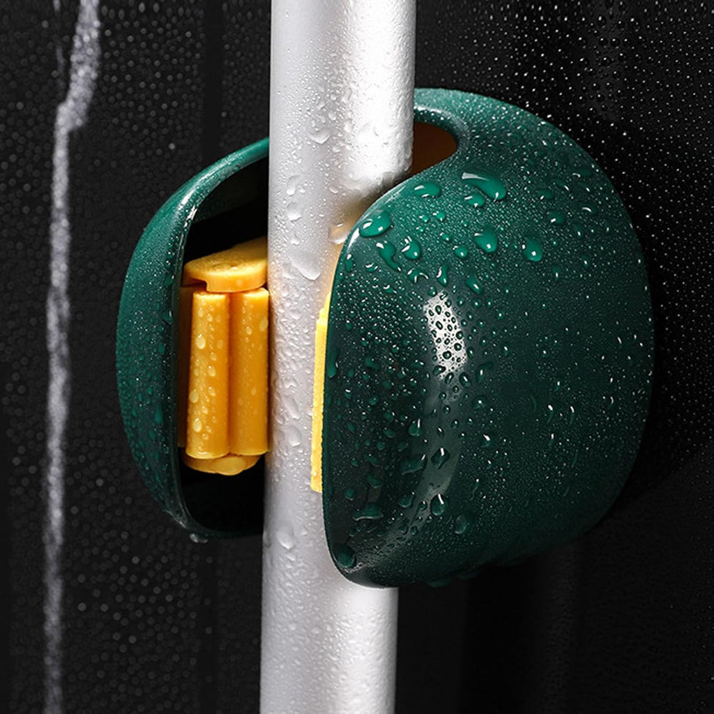 A close-up of a dark green waterproof door stopper with yellow rubber pads, shown attached to a silver metal pole with water droplets on a wet dark background.