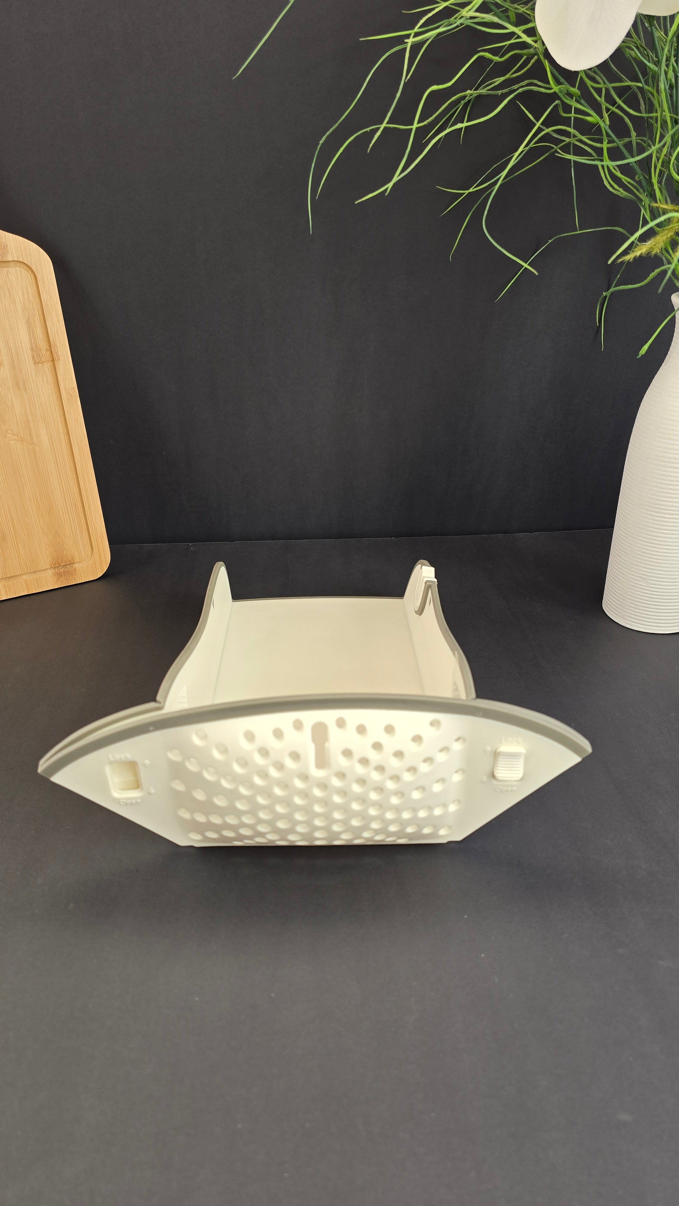 Folded multifunctional cutting board showing its compact space-saving design