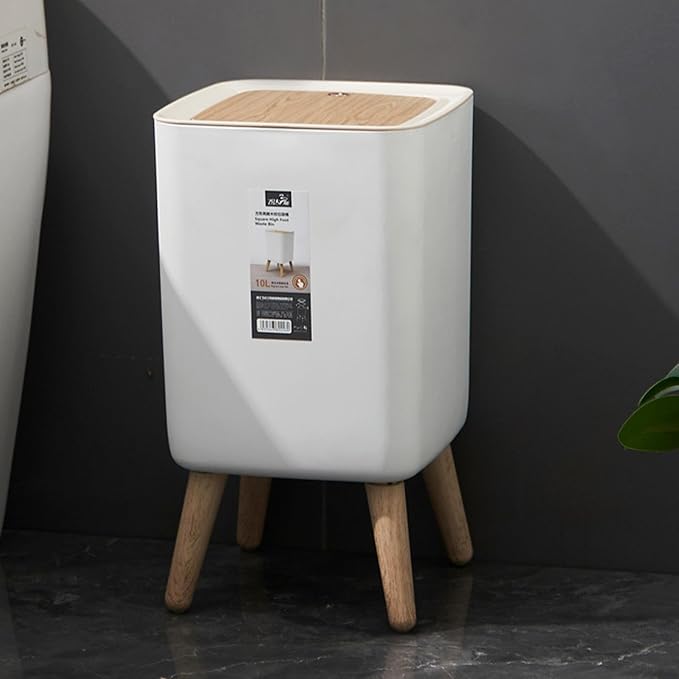 White storage bin with wooden legs against a dark wall