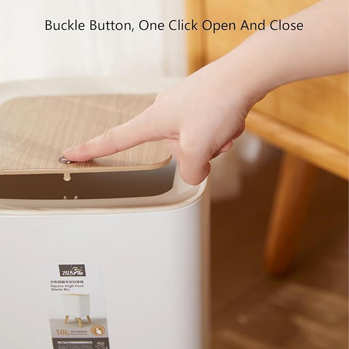 A hand demonstrates the open-and-close function of a white trash bin with a light wood-grain lid, with text overlay reading 'Buckle Button, One Click Open And Close'.