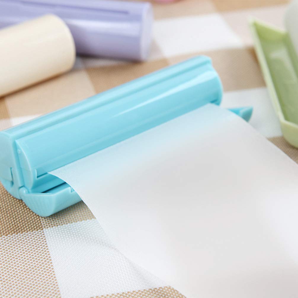 Blue lamination roller with a sheet of clear plastic on a checkered surface