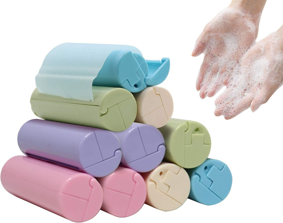A stack of pastel-colored plastic soap dispenser bottles in pink, blue, purple, green, and beige, shown next to a pair of hands lathered with soap foam on a white background.