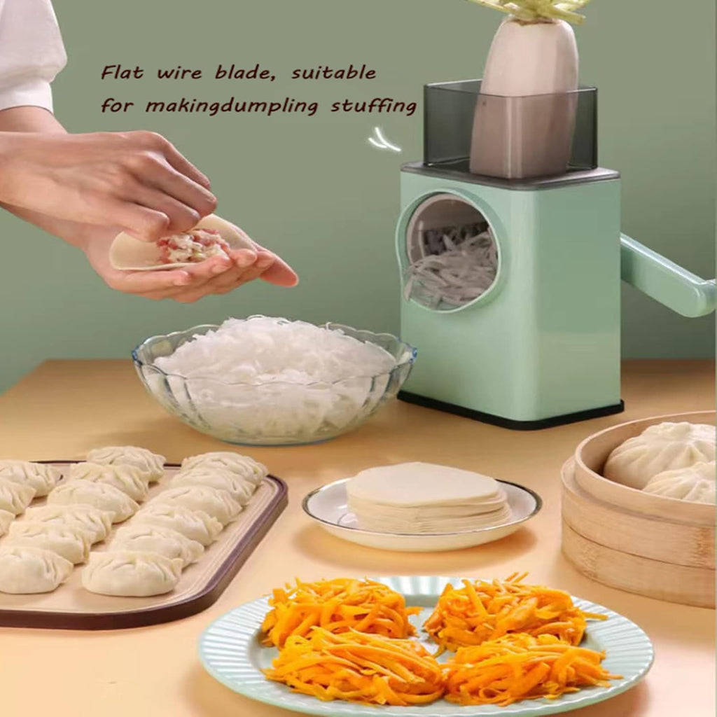 A hand uses a manual dumpling stuffing machine with a mint green body and clear top hopper, shown alongside bowls of dough, shredded orange vegetables, and steamed dumplings on a table. Text on the image describes the flat wire blade suitable for making dumpling stuffing.