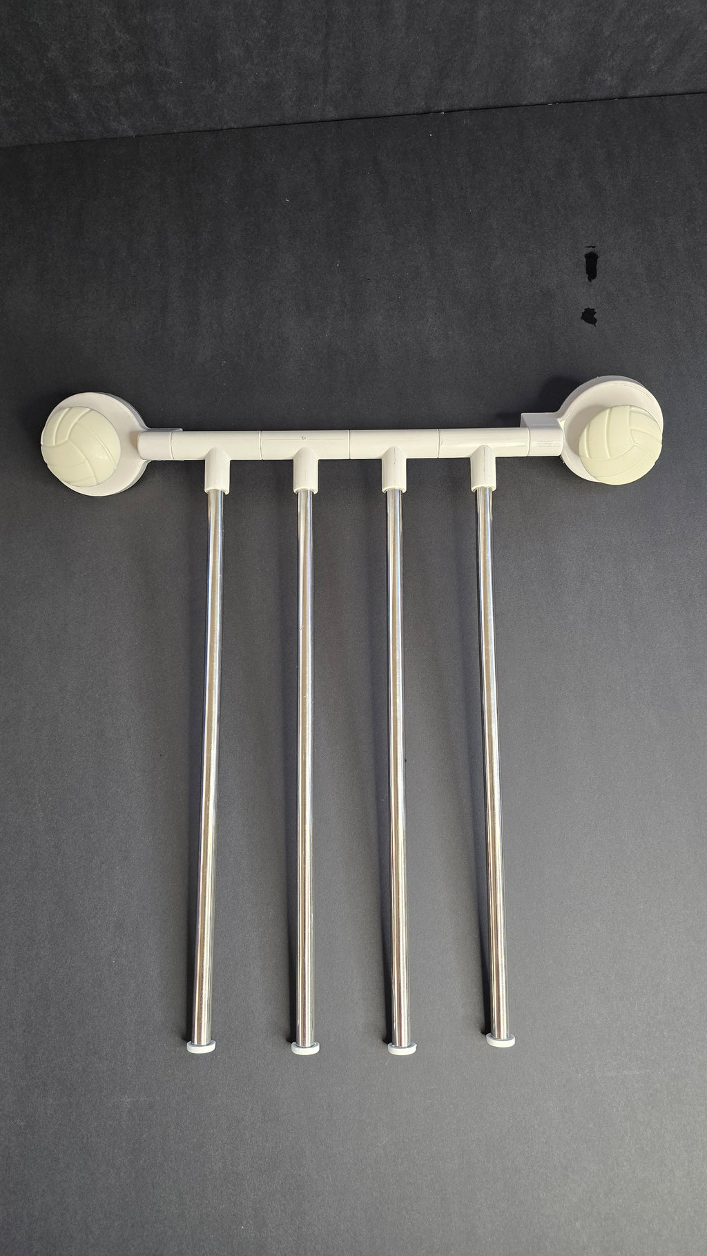 Reverse view of the four stainless-steel towel arms and white mounting rail