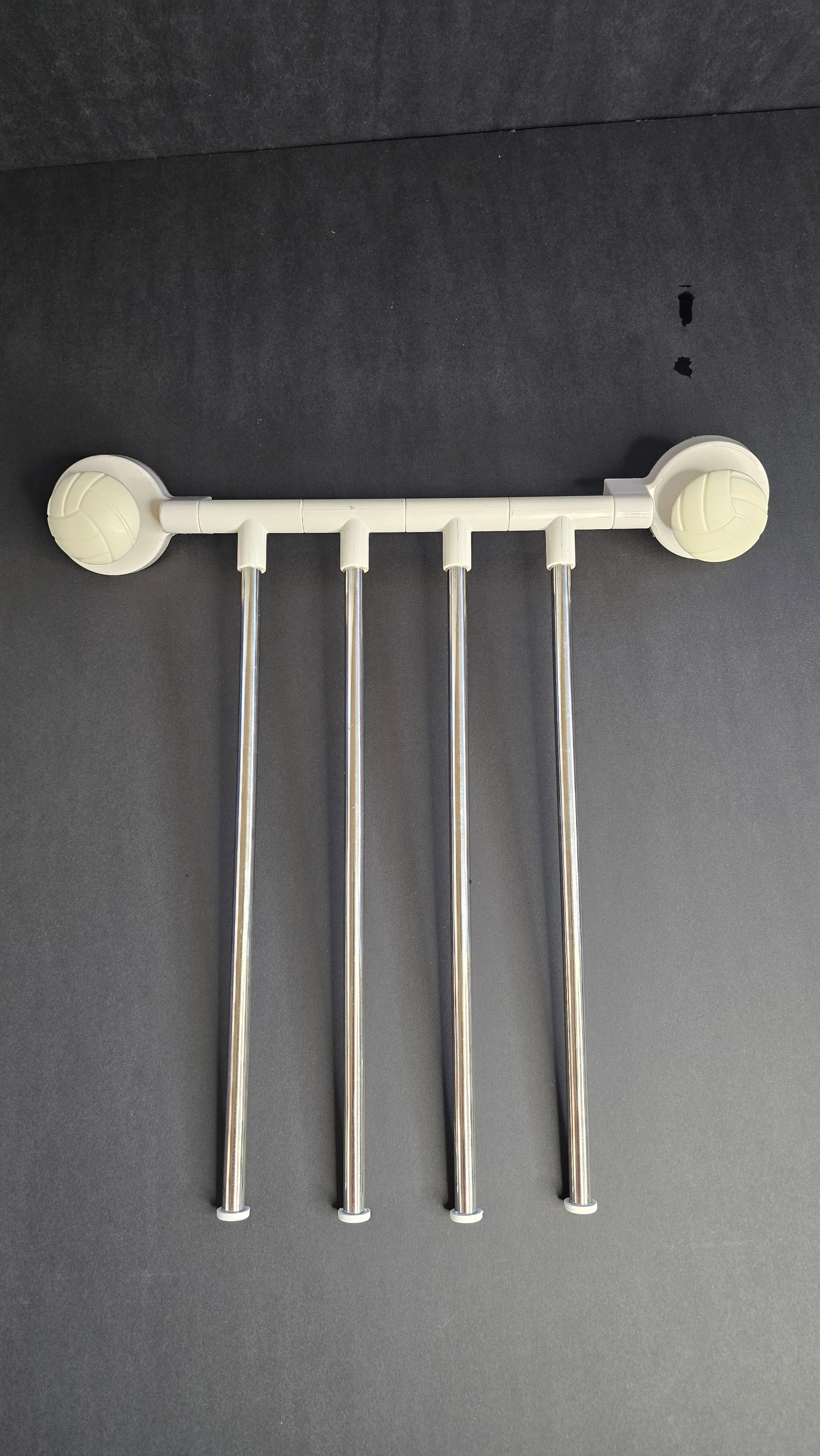 Reverse view of the four stainless-steel towel arms and white mounting rail