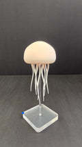 Beiryta sound-reactive jellyfish lamp glowing warm white on a clear stand