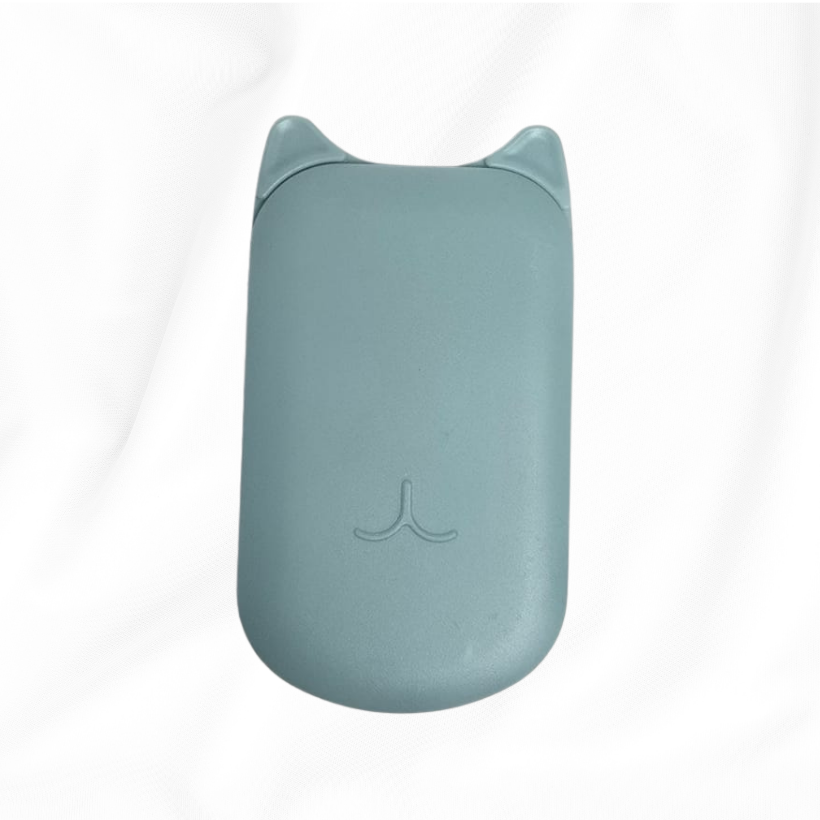 A light blue-gray silicone mouse pad with cat-ear cutouts at the top and a small embossed cat face logo in the center, resting on a white fabric background.