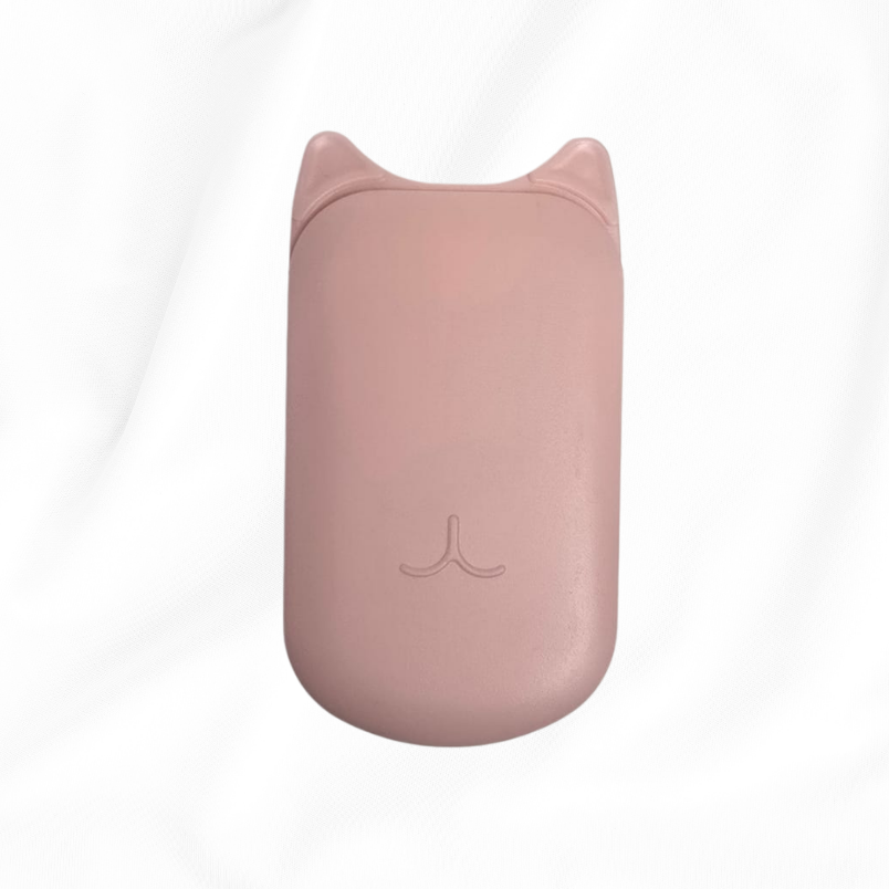 A small, rounded rectangular pink device with cat-ear details on top, centered on a white fabric background.