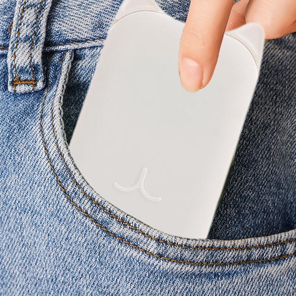 A close-up of a white rectangular pocket clip or card holder being inserted into the pocket of blue denim jeans, with a finger holding the top edge.