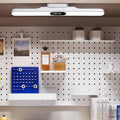 White rechargeable LED light bar with digital clock installed above a home workspace