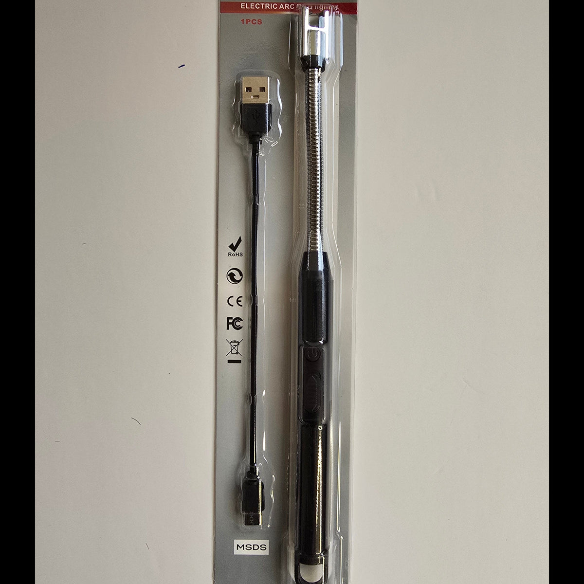 A black and silver USB extension cable in its original retail blister packaging, displayed against a plain off-white background.