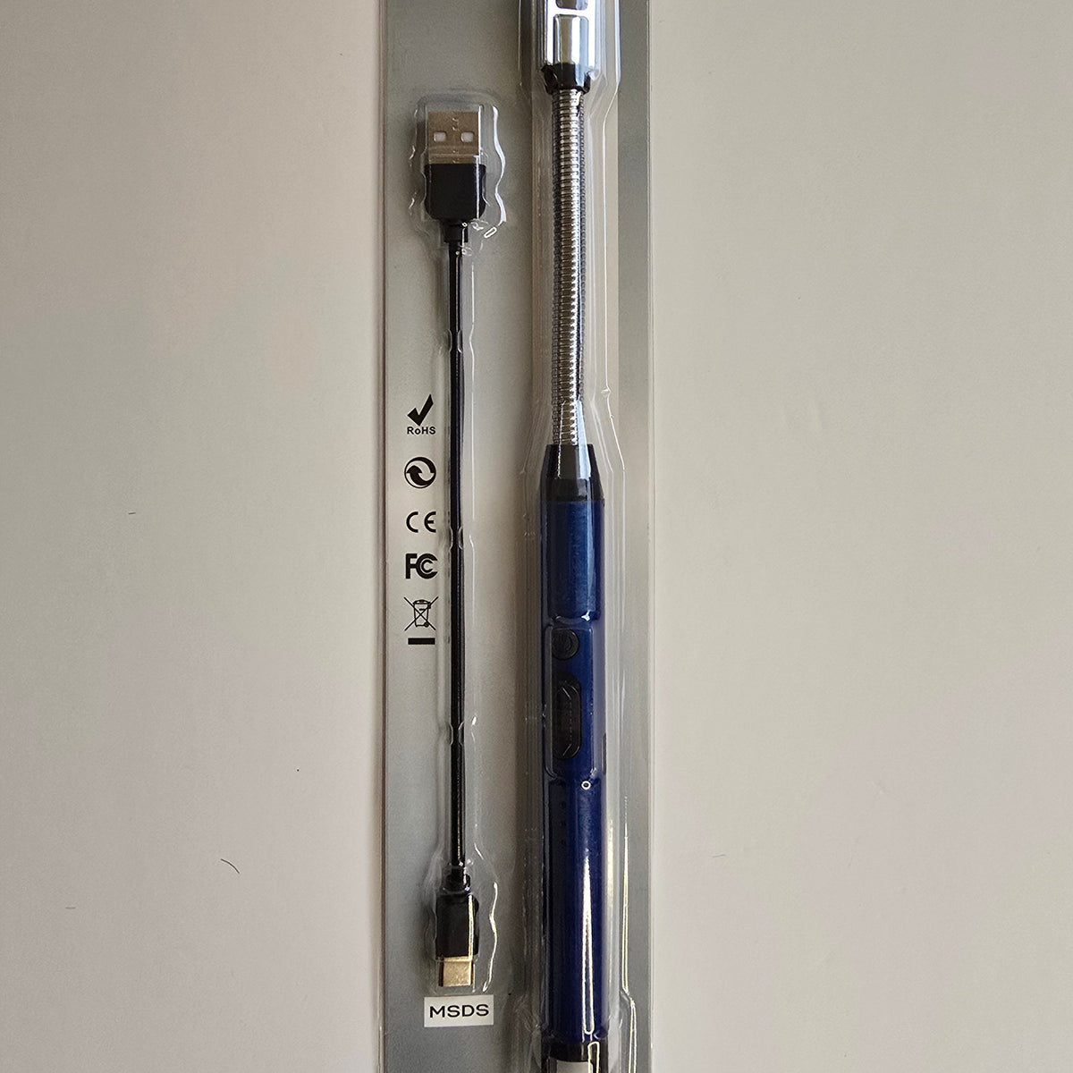 A blue and silver USB extension tool with a built-in USB cable, packaged in a clear blister pack on a light gray background.