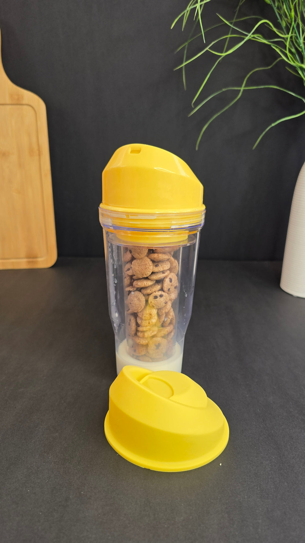 Yellow cereal and milk cup showing its open drinking lid