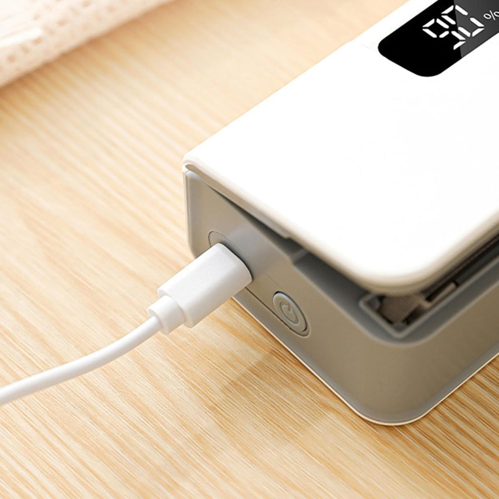 Power bank with a USB cable plugged into it on a wooden surface