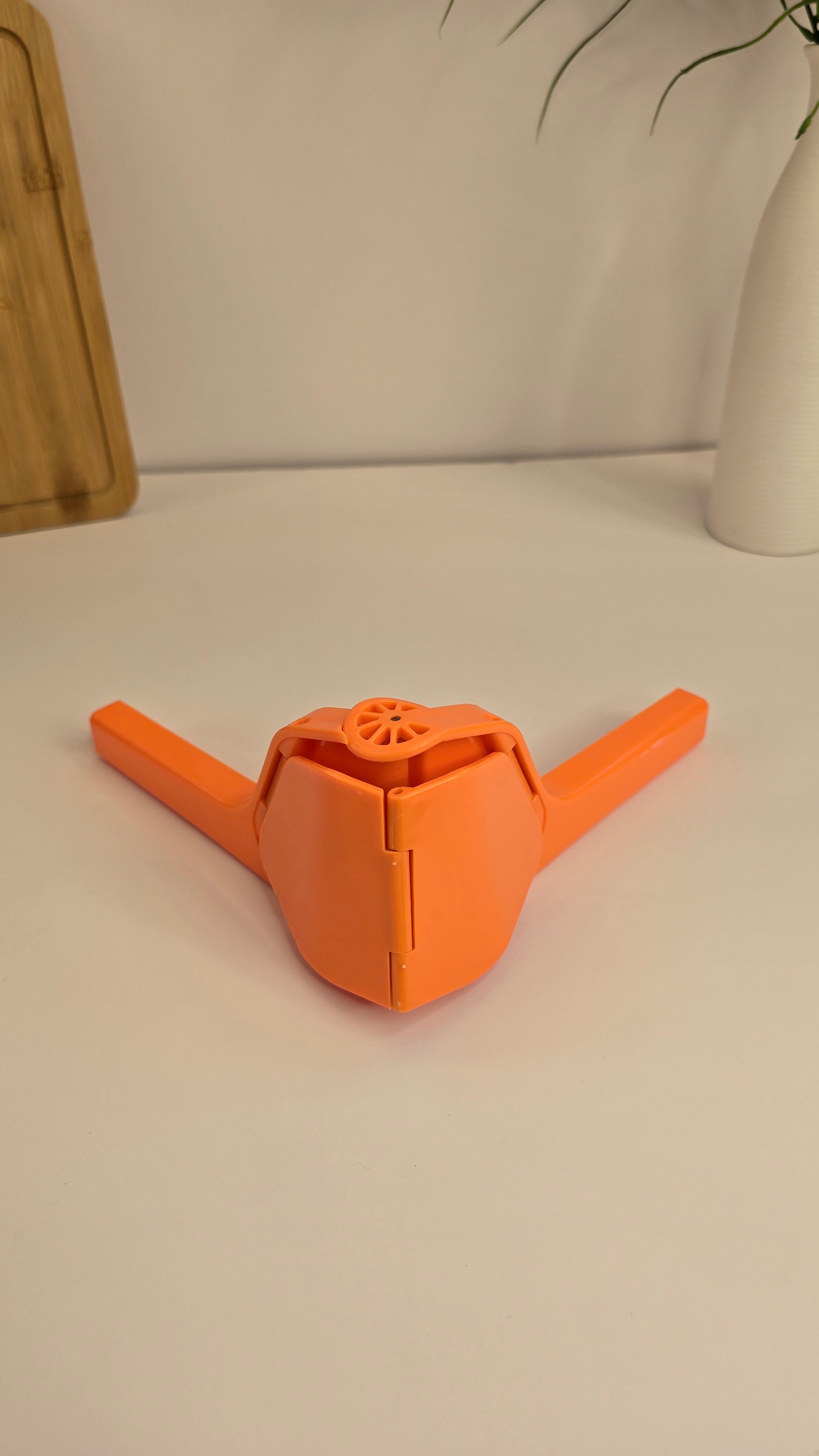 Orange lemon juicer displayed with fresh lemons