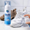 Shoe cleaning foam being applied to a white sneaker